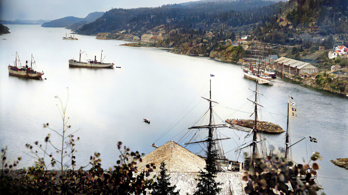 Langangsfjorden var episenteret for produksjon og eksport av naturis i distriktet.  Her lå ishusene på rad og rekke langs begge sider av fjorden.   Foto: Telemark museum/Digital kolorering: Tony Armstrong